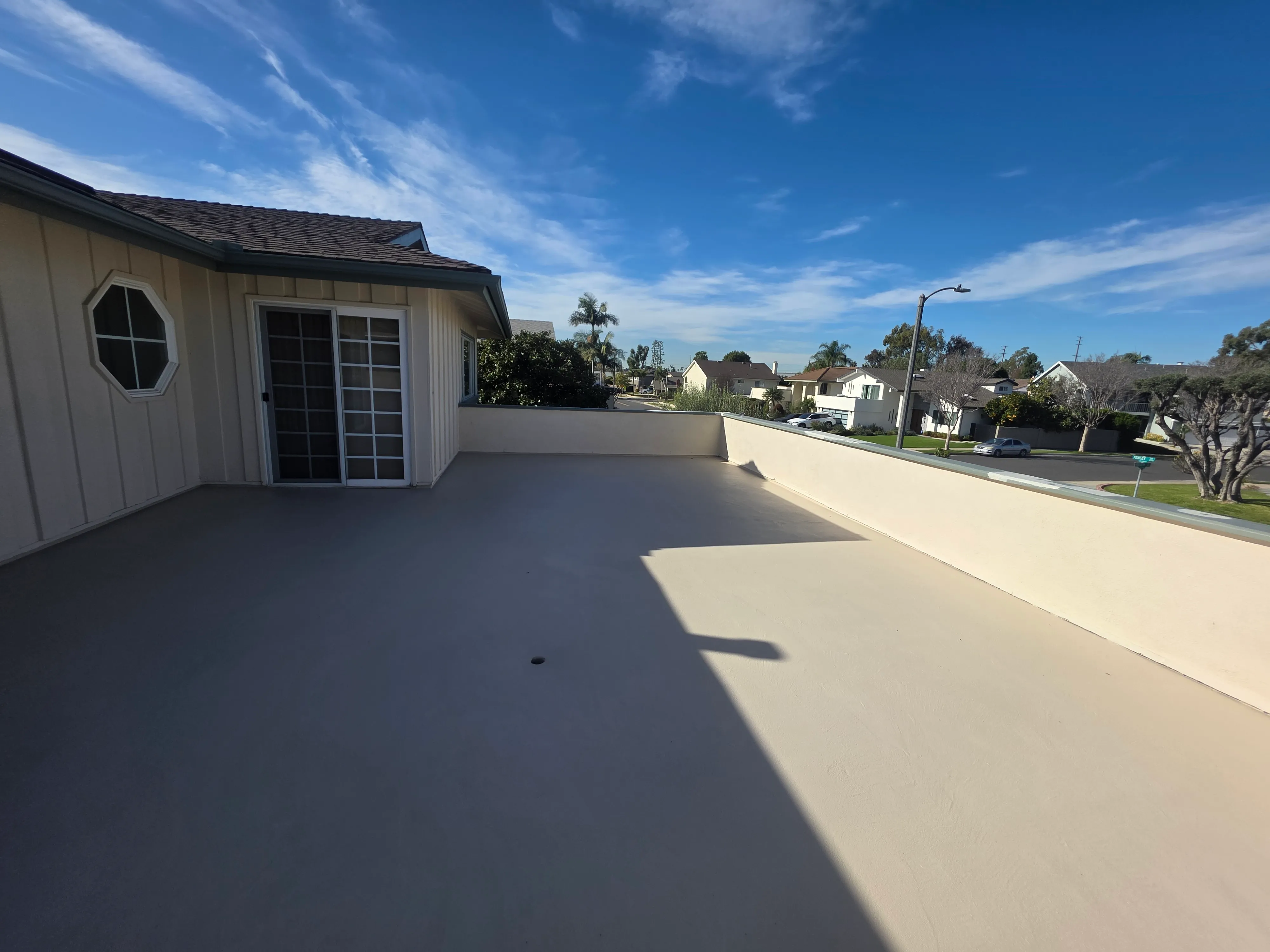 A beautiful outdoor balcony deck in Los Angeles receiving a multi-layer waterproof liquid membrane coating