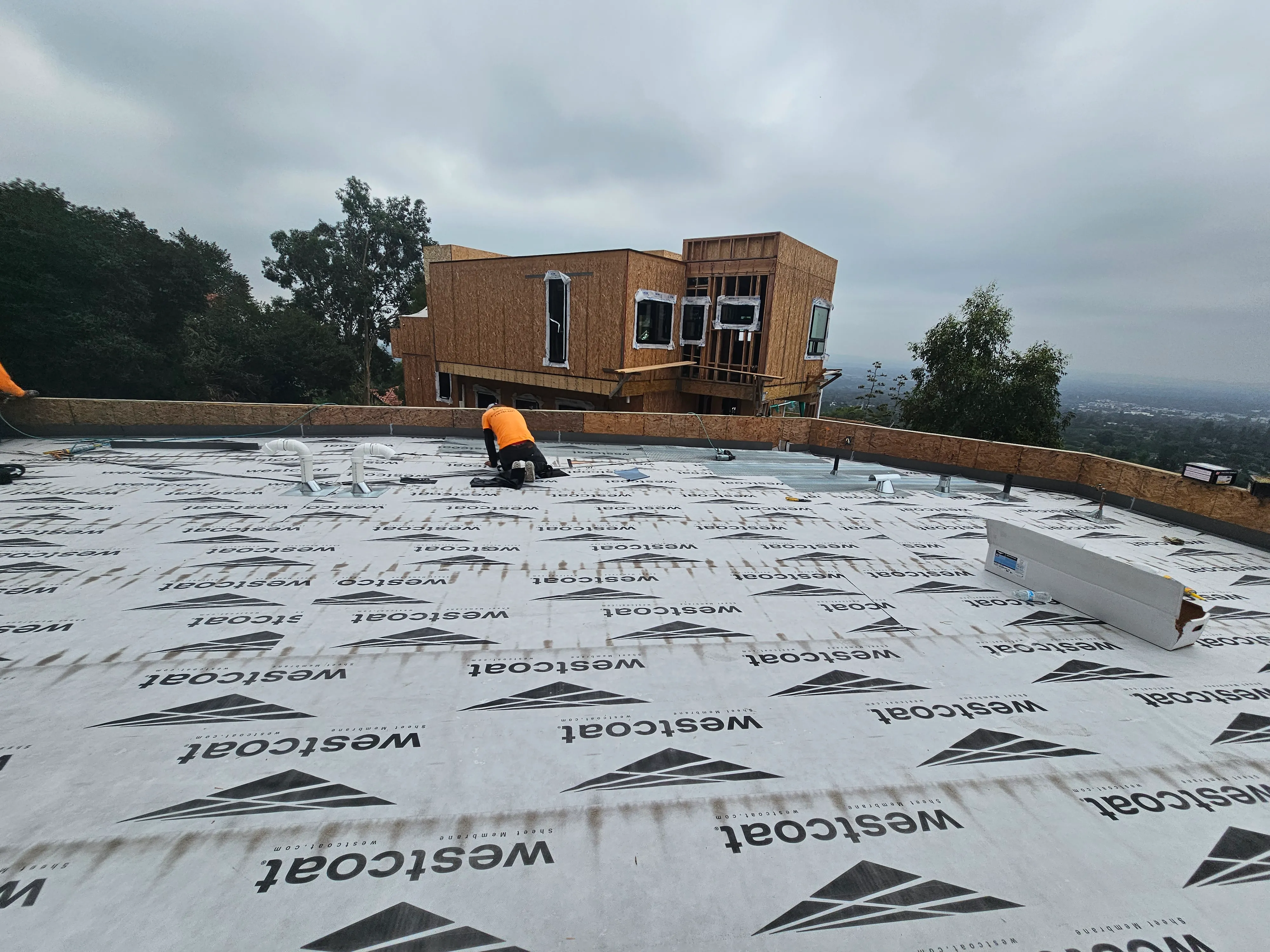 Industrial-grade waterproofing application on a large commercial flat roof in Orange County