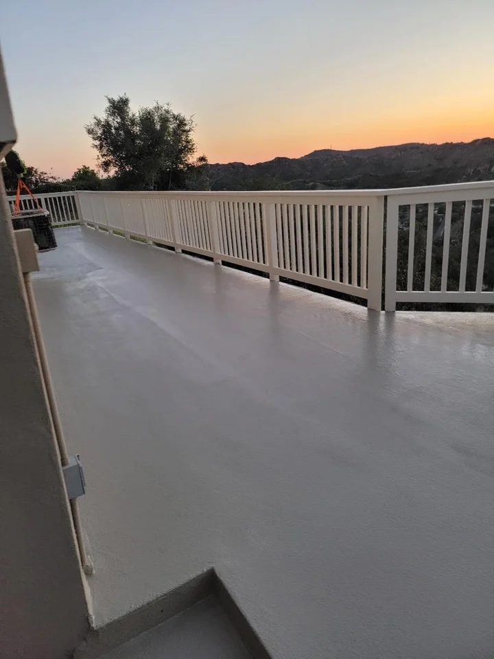 Professional waterproofing team applying protective coating to a coastal deck in Southern California